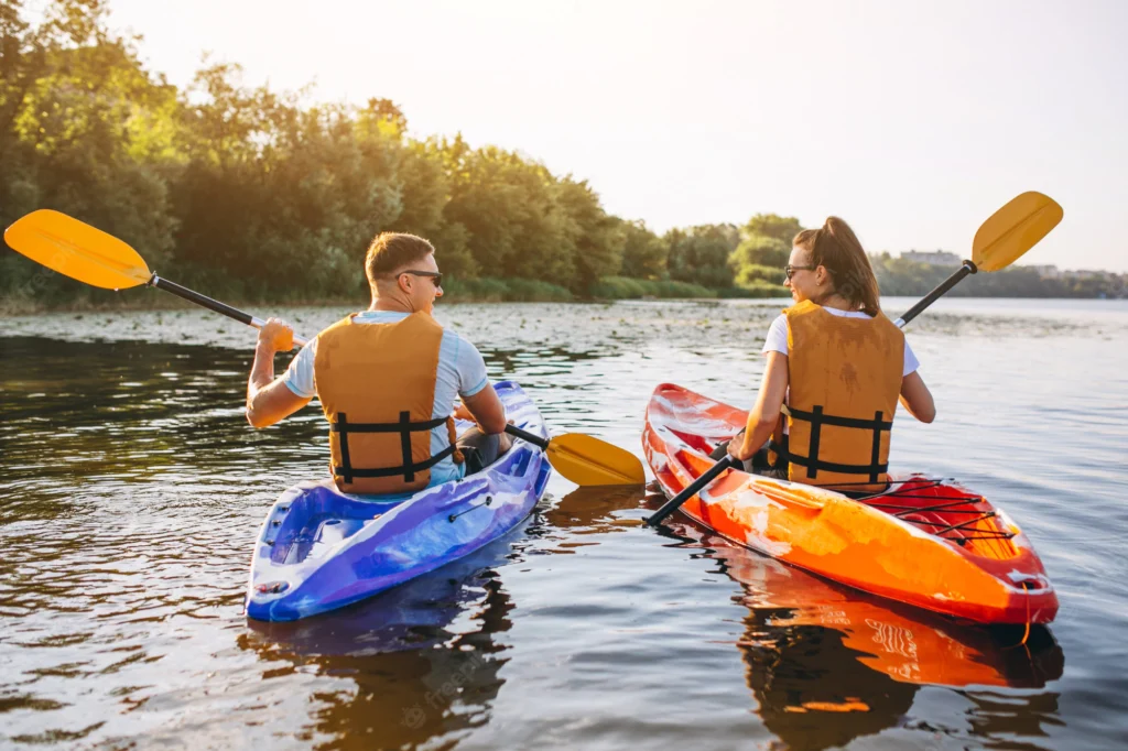 couple-together-kayaking-river_1303-16040